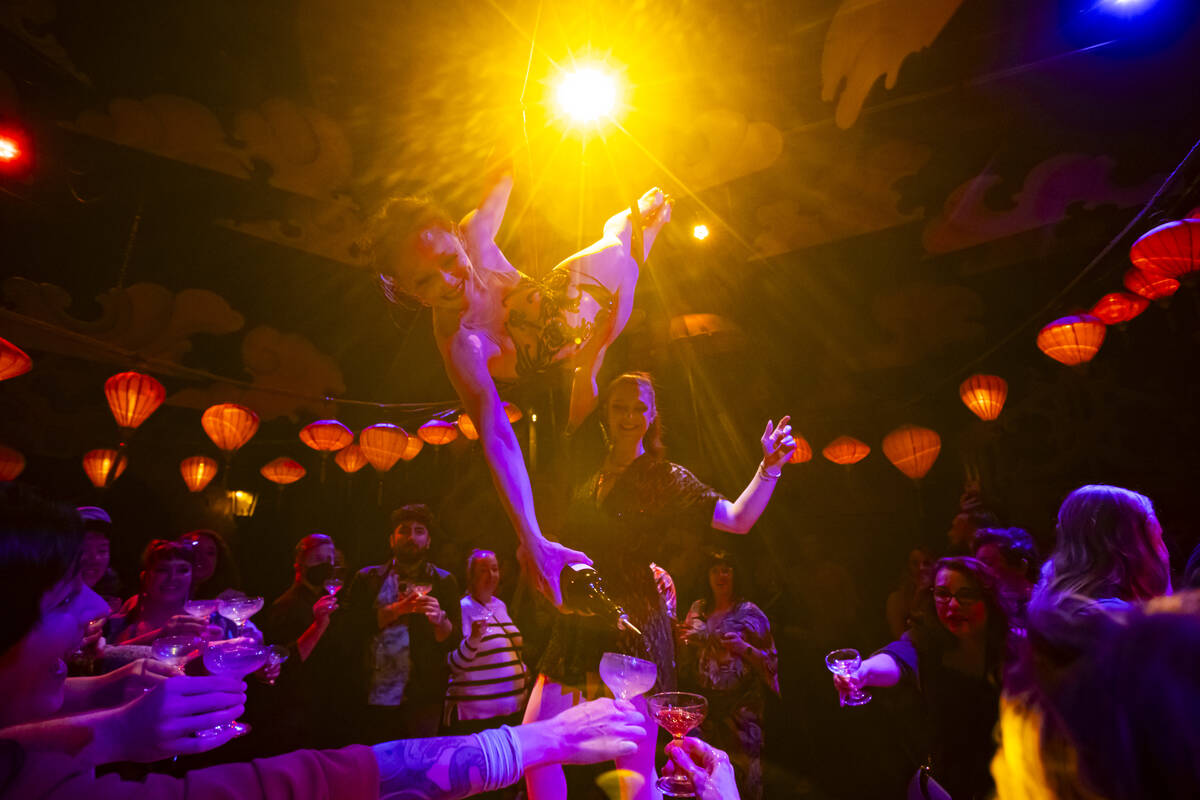 Head distiller Mary Dempsey, who is also an aerialist, pours rum for guests during the closing ...