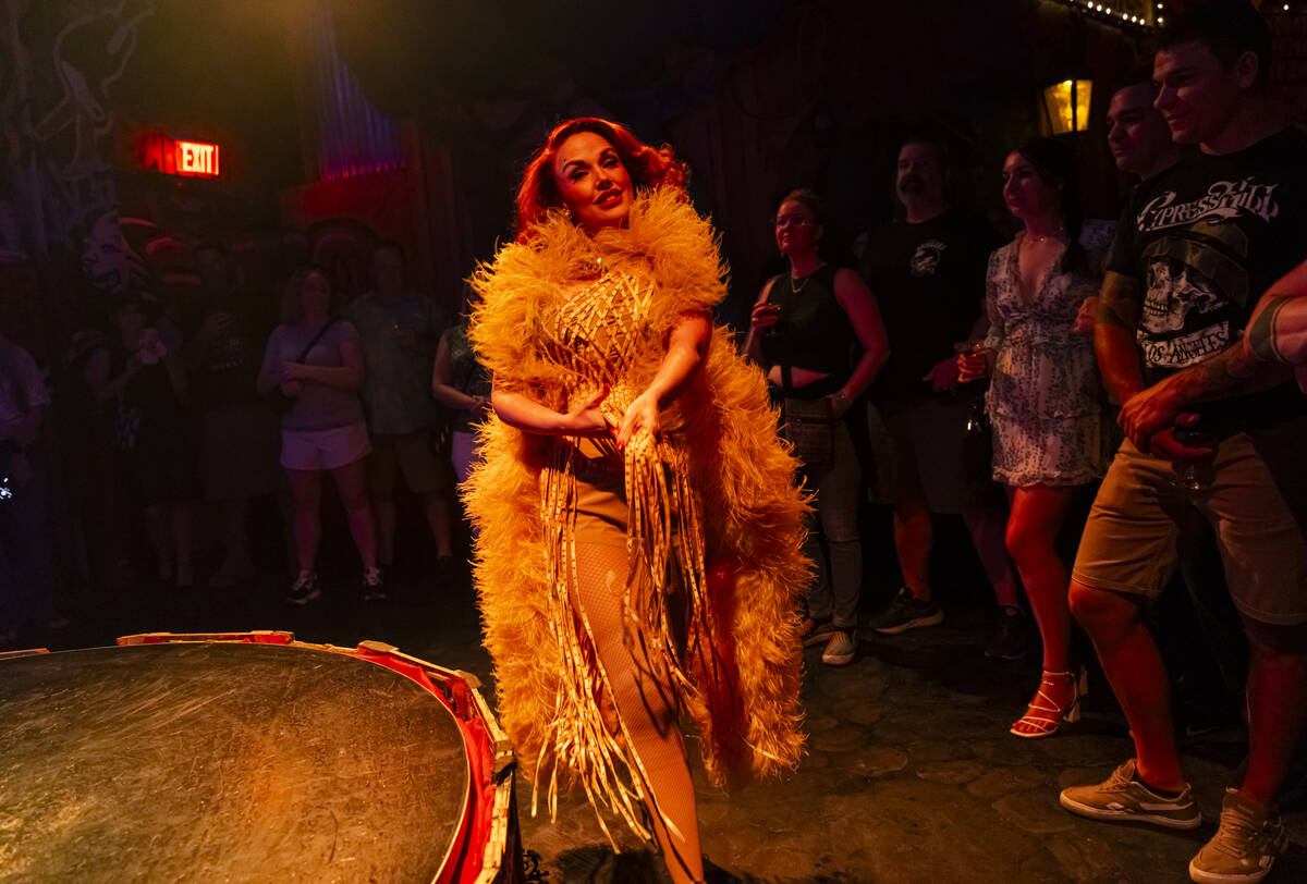 Burlesque artist Ginger Watson performs during the closing night of Lost Spirits Distillery at ...
