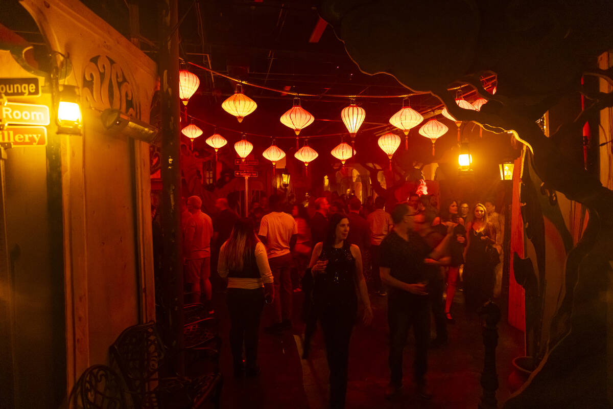 Attendees walk around during the closing night of Lost Spirits Distillery at Area15 on Monday, ...