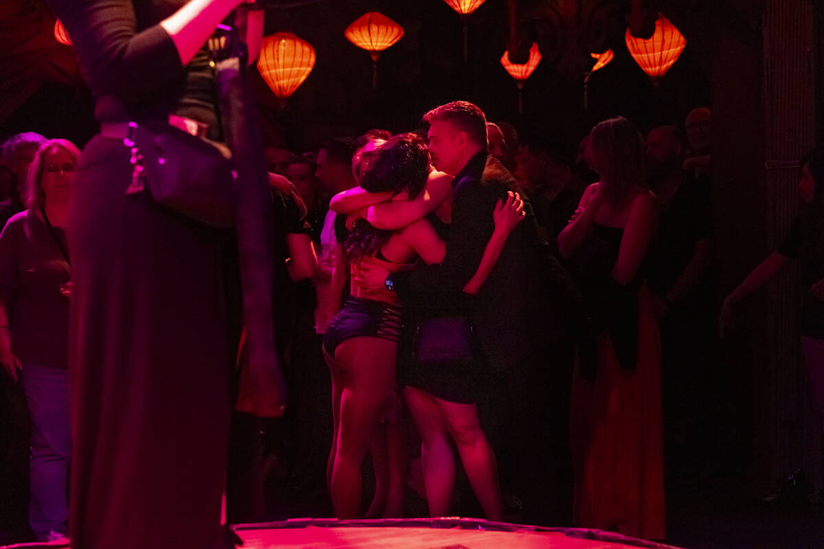 Performers embrace during the closing night of Lost Spirits Distillery at Area15 on Monday, Apr ...