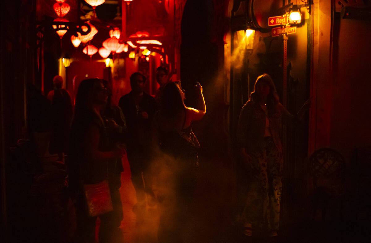 Guests walk around the venue during the closing night of Lost Spirits Distillery at Area15 on M ...