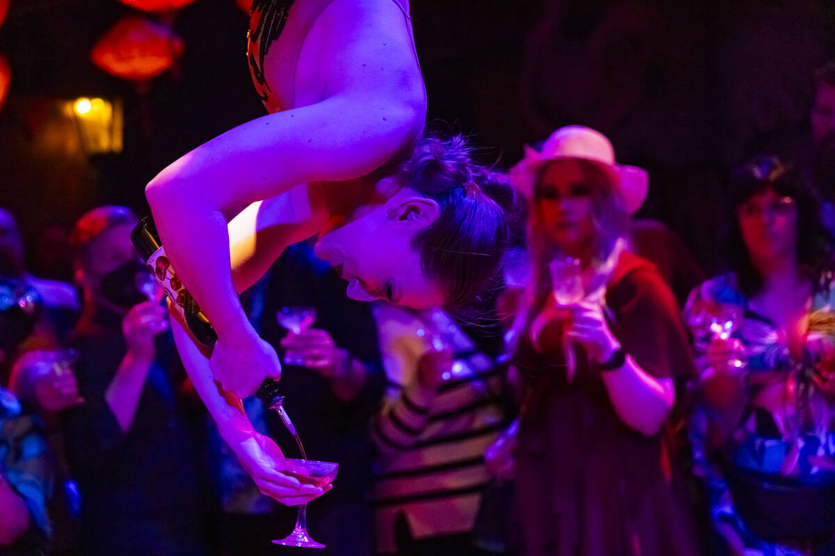 Head distiller Mary Dempsey, who is also an aerialist, pours rum for guests during the closing ...