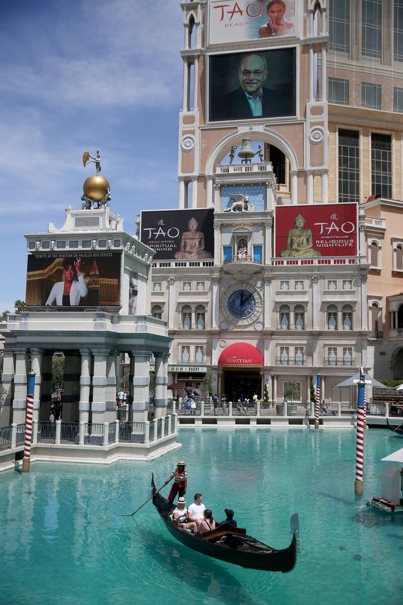 Portraits of founding employees are displayed on The Venetian marquee to celebrate the 20th ann ...