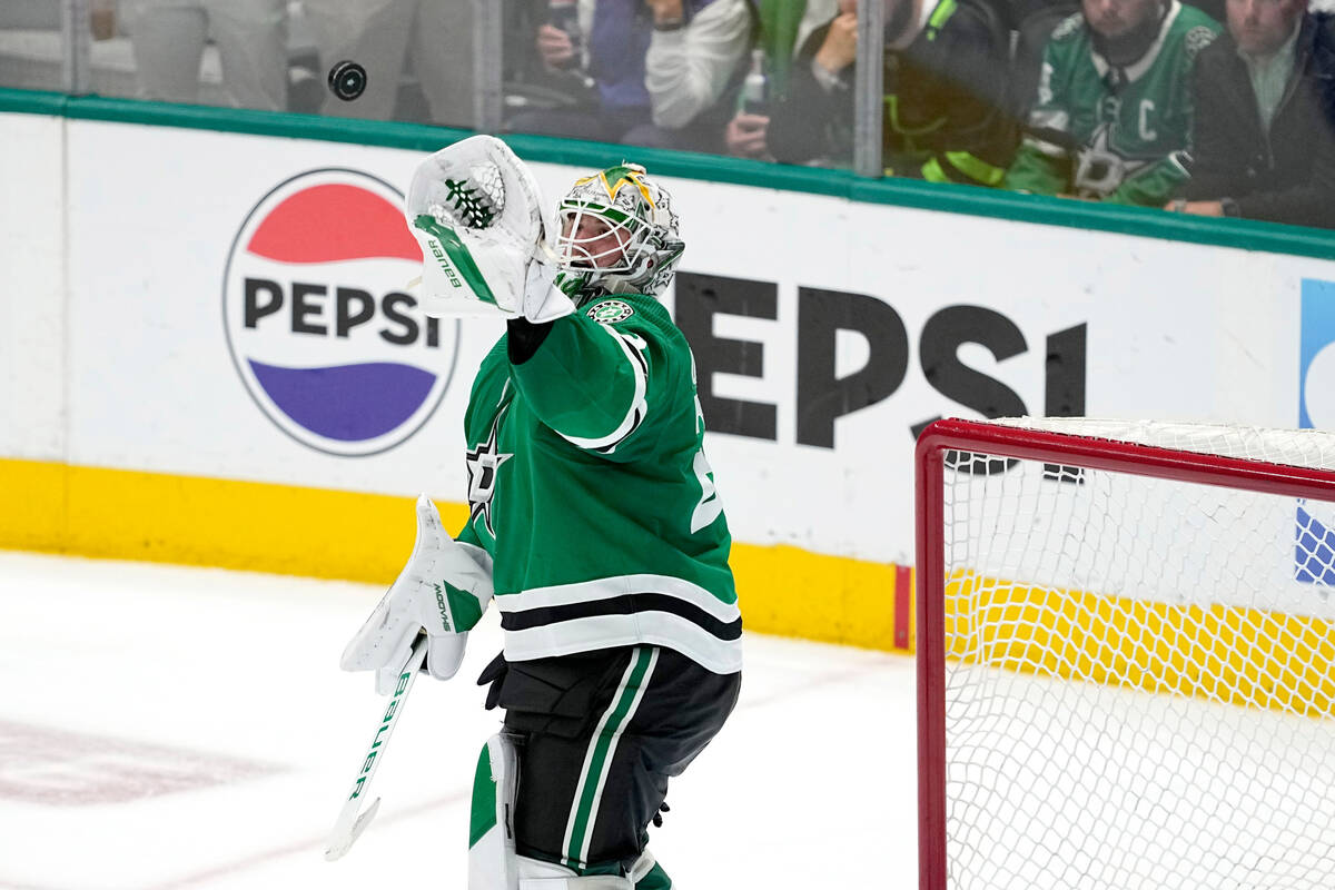 Dallas Stars goaltender Jake Oettinger (29) reaches up to glove a shot by the Vegas Golden Knig ...