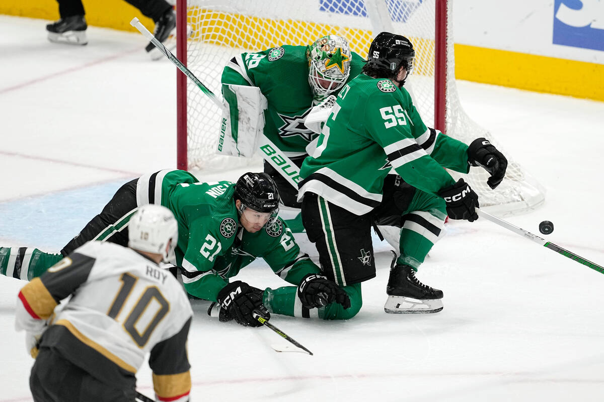 Dallas Stars left wing Jason Robertson (21) and defenseman Thomas Harley (55) lay out in front ...
