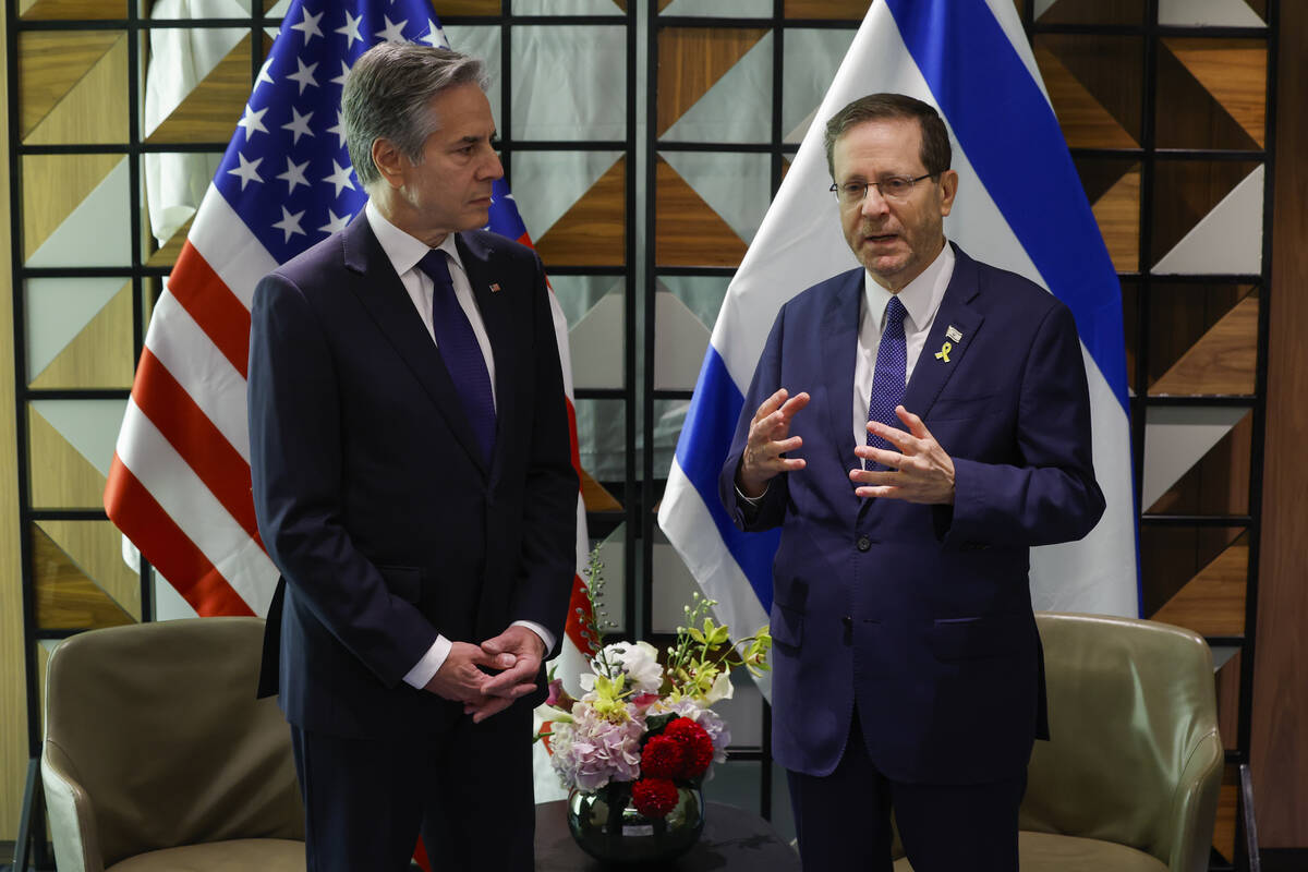 U.S. Secretary of State Antony Blinken, left, and Israeli President Isaac Herzog talk during th ...