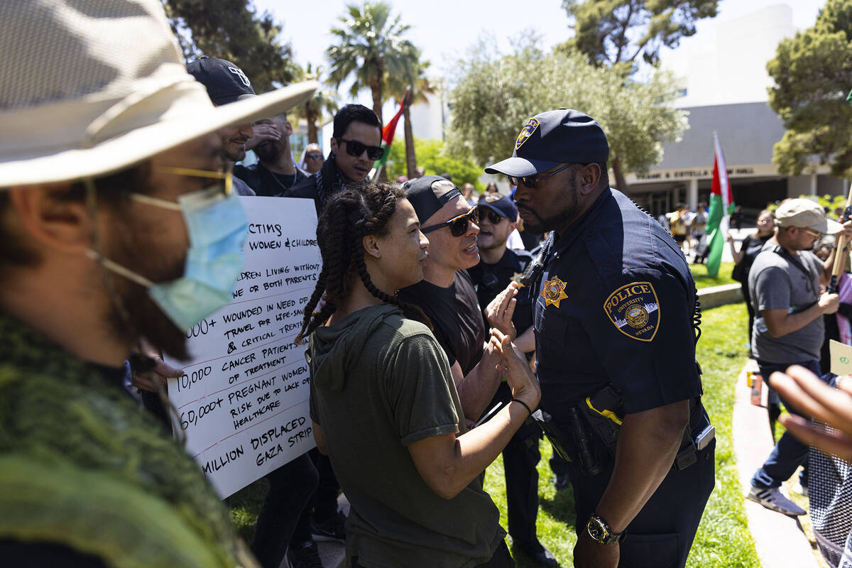 A UNLV police officer talks with pro-Palestianian protesters on campus at UNLV on Wednesday, Ma ...