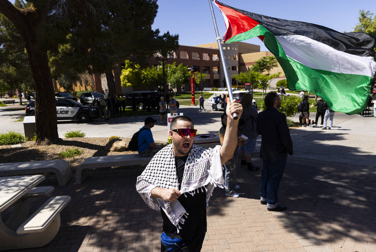 A pro-Palestianian protester shouts toward a small group of pro-Israel supporters and counter-d ...