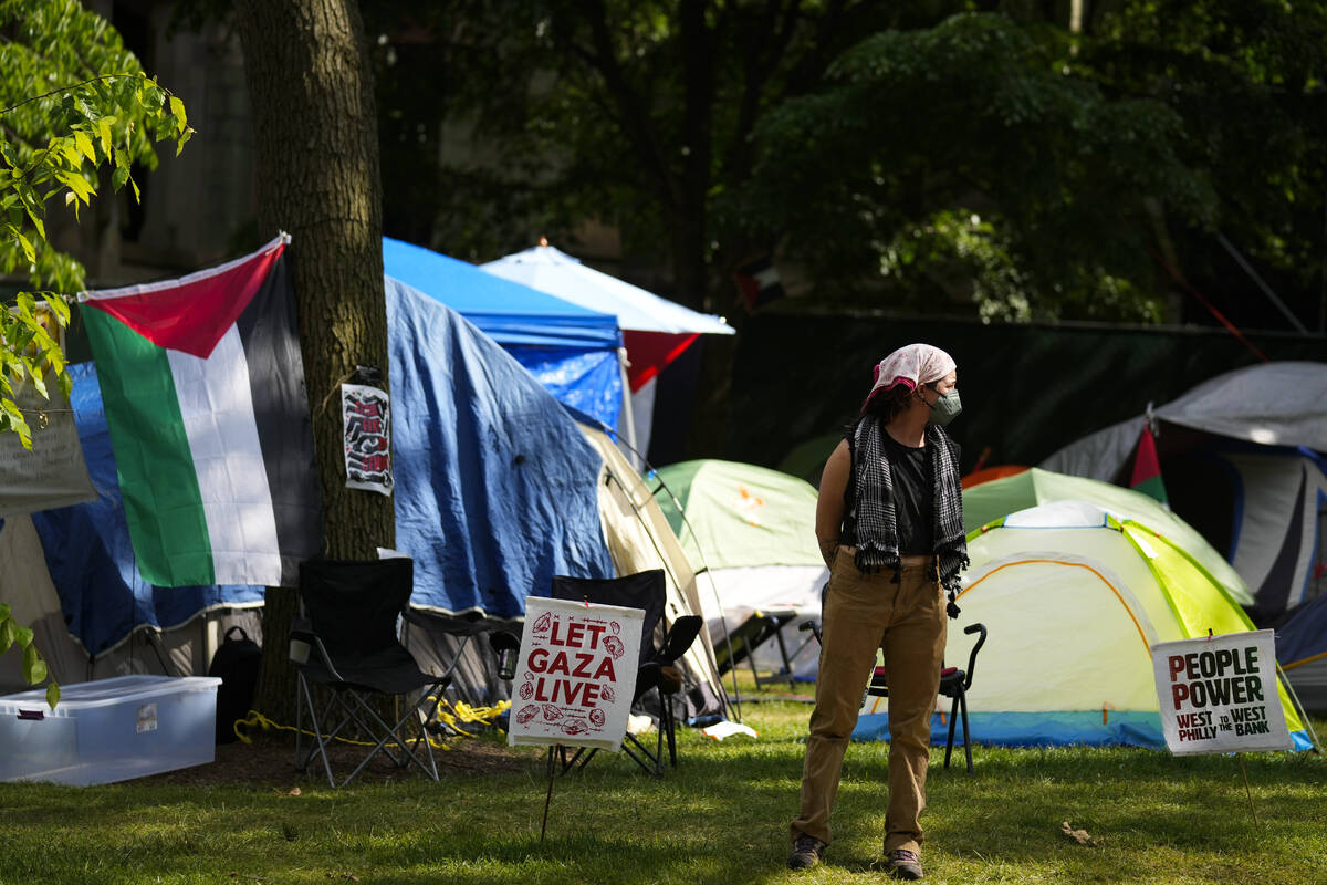 A person stands at a Gaza Solidarity Encampment at the University of Pennsylvania in Philadelph ...