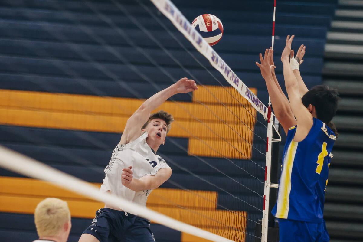 Centennial outside hitter Lincoln Larson (10) forces the ball over the net during a boys volley ...