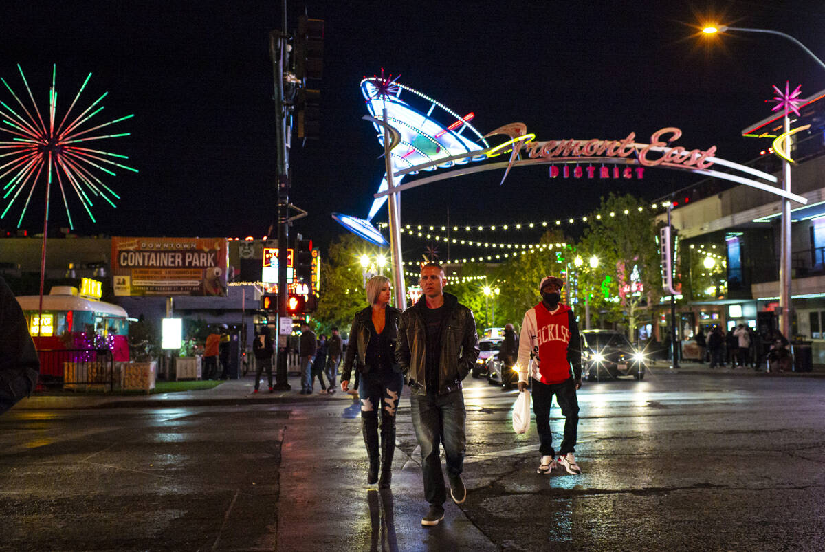 People walk around Fremont East in downtown Las Vegas on Saturday, Nov. 21, 2020, where many ro ...