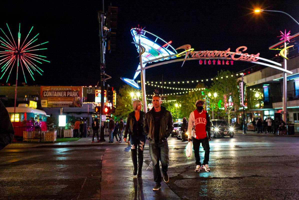 People walk around Fremont East in downtown Las Vegas on Saturday, Nov. 21, 2020, where many ro ...