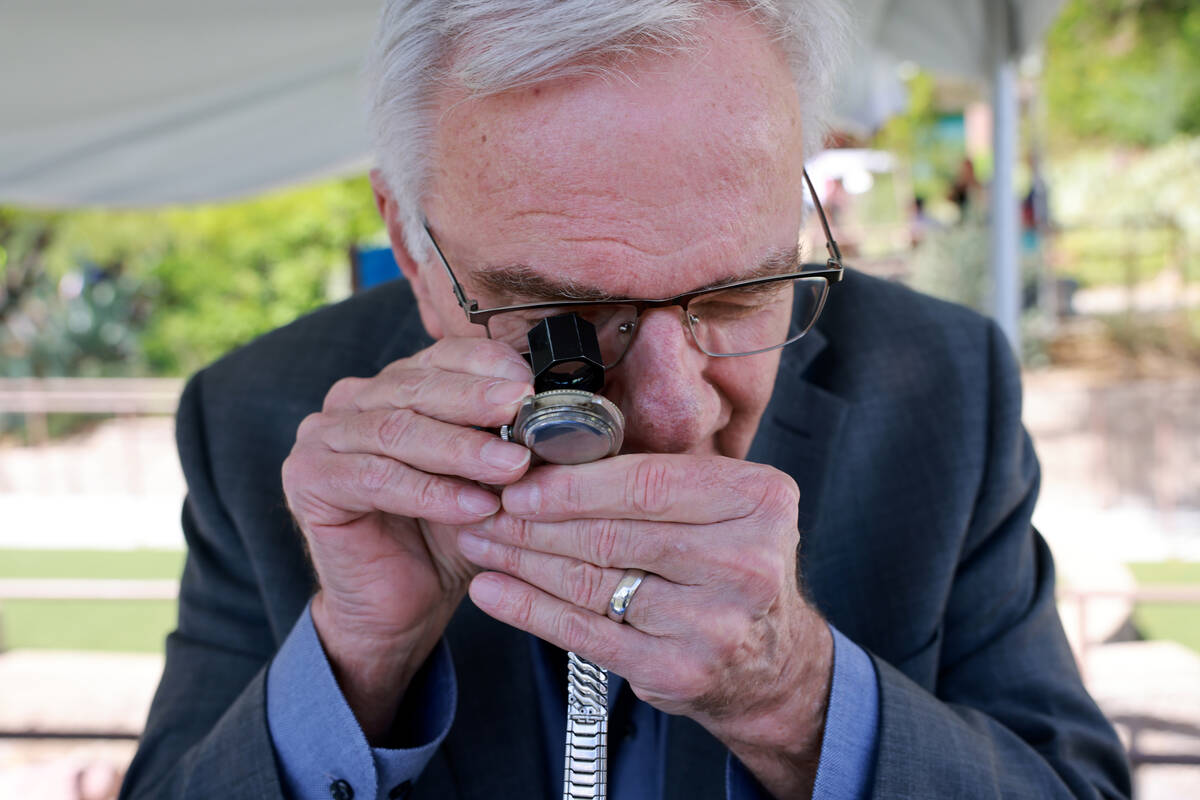 Expert Jim Wolf examines an original Rolex during an Antiques Roadshow taping event at the Spri ...