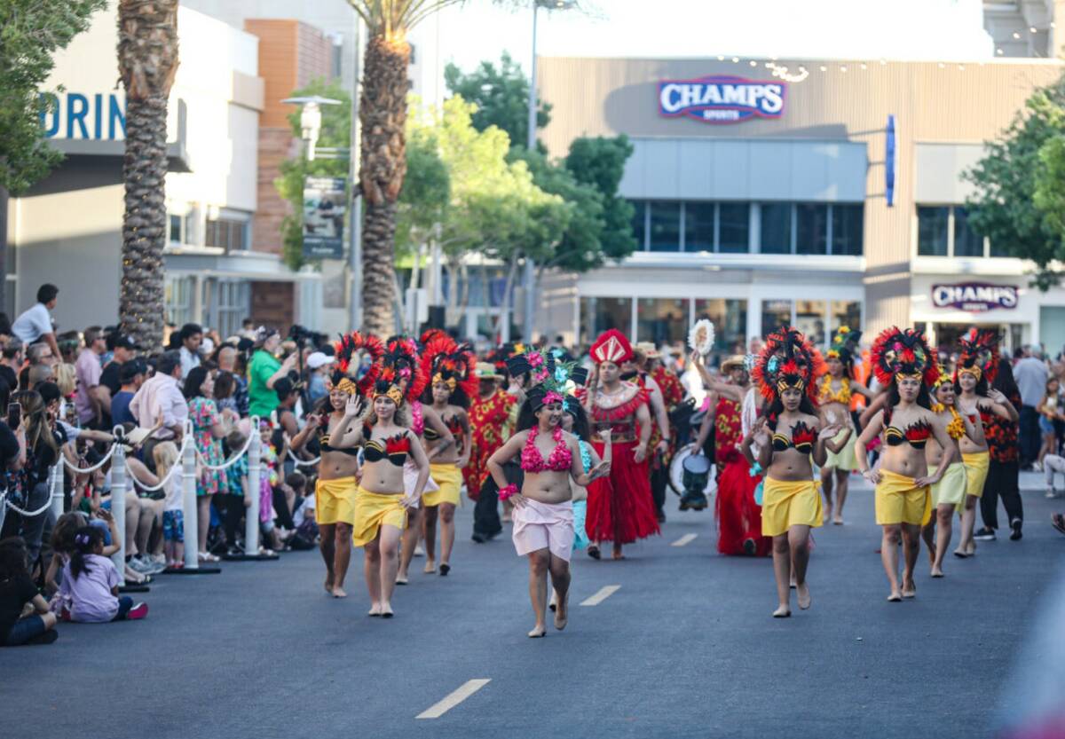 Members of the Tevakanui Polynesian Dance Group walk the Lei Day Parade, a celebration of Asian ...