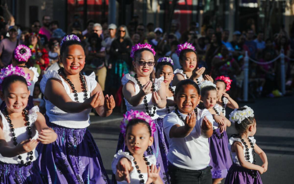Members of the Nani Ola Hawaiian Dance Company dance during the Lei Day Parade, a celebration o ...