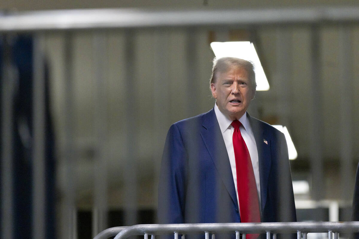 Former President Donald Trump talks to reporters as leaves the courtroom following the day's pr ...