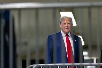 Former President Donald Trump talks to reporters as leaves the courtroom following the day's pr ...