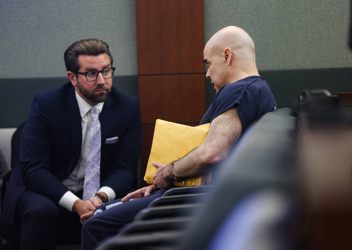 Attorney Michael Horvath speaks with his client Robert Telles, the former public official accus ...