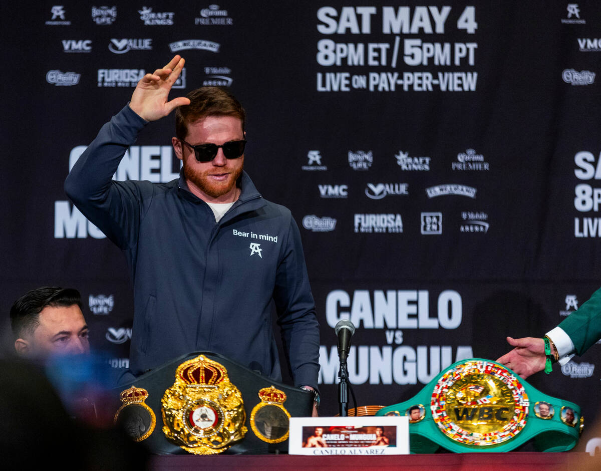Canelo Alvarez greets the crowd as he arrives on stage during the final press conference with o ...
