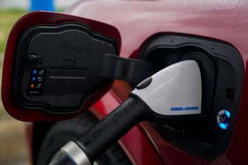A 2023 Ford Mustang Mach-E charges, Friday, March 8, 2024, at an electric vehicle charging stat ...