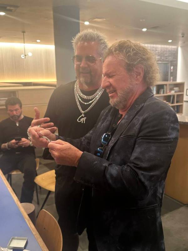 Guy Fieri reveals a custom key chain to Sammy Hagar on April 30, 2024. The key chain, a replica ...