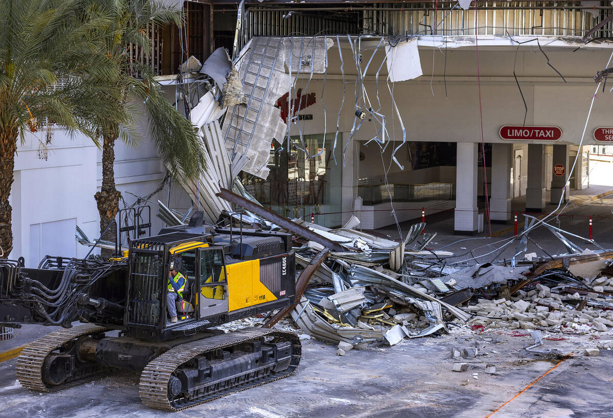Large machinery is moved as demolition continues about the porte-cochere at the Tropicana on Th ...