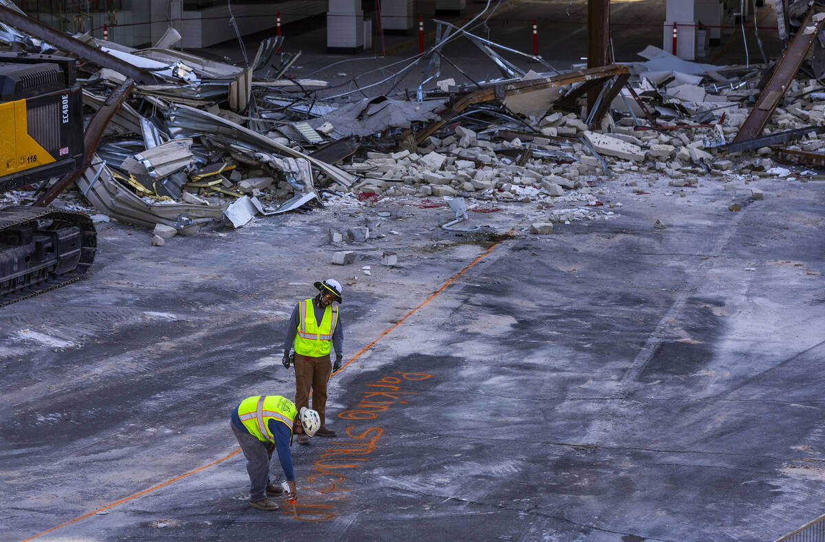 A crew marks the pavement as demolition continues of the porte-cochere at the Tropicana on Thur ...