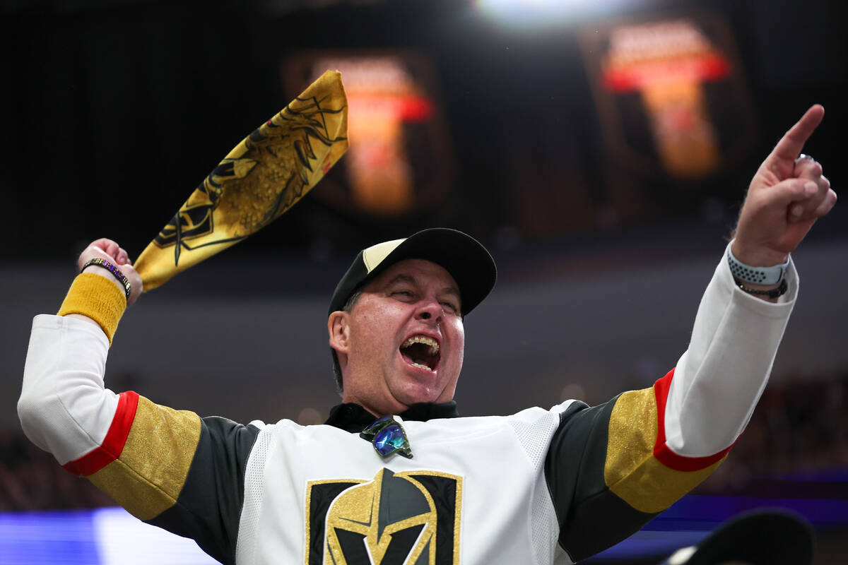 A Golden Knights fan cheers for his team during the first period in Game 6 of an NHL hockey Sta ...