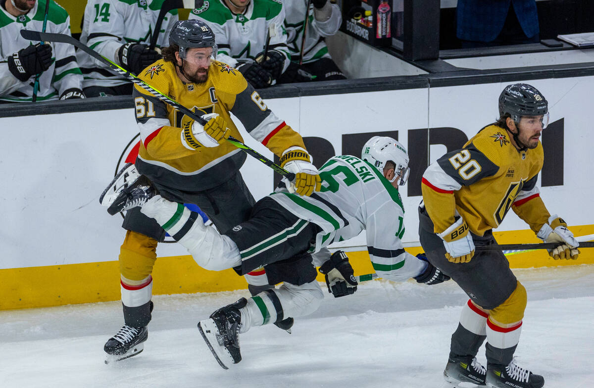 Golden Knights right wing Mark Stone (61) checks Dallas Stars center Joe Pavelski (16) to the i ...