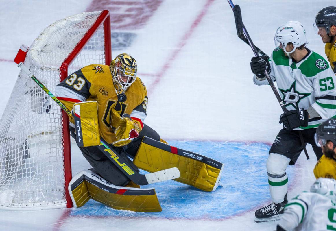 Golden Knights goaltender Adin Hill (33) makes save close to Dallas Stars center Wyatt Johnston ...