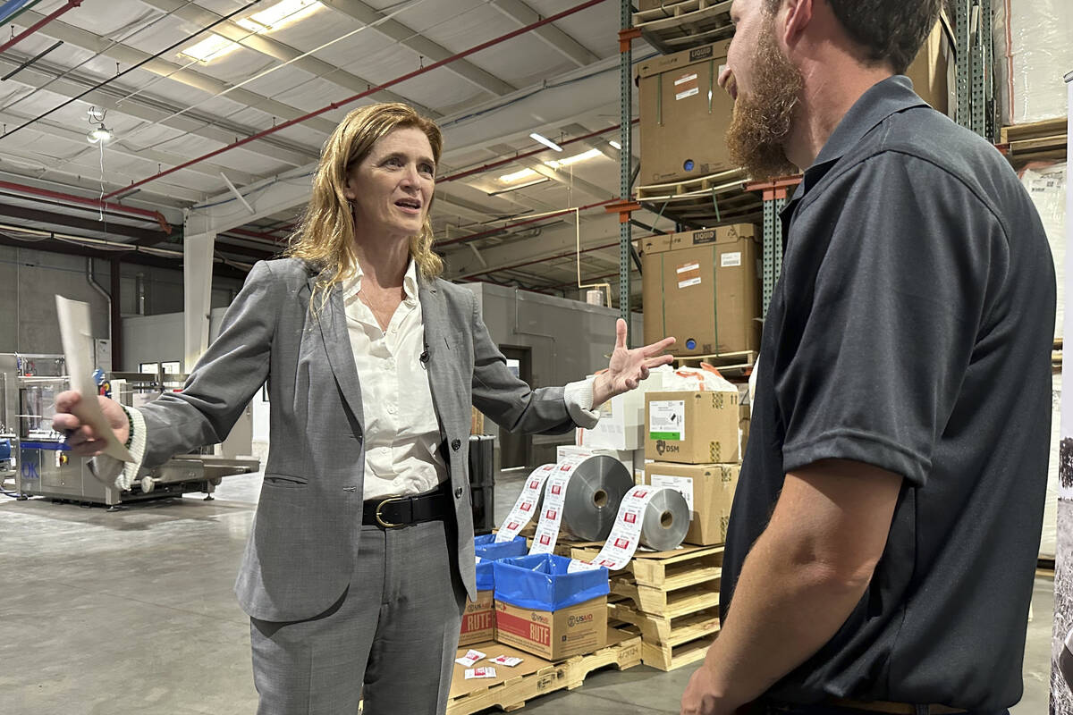 USAID Administrator Samantha Power talks with a worker Friday, May 3, 2024, during a tour of th ...
