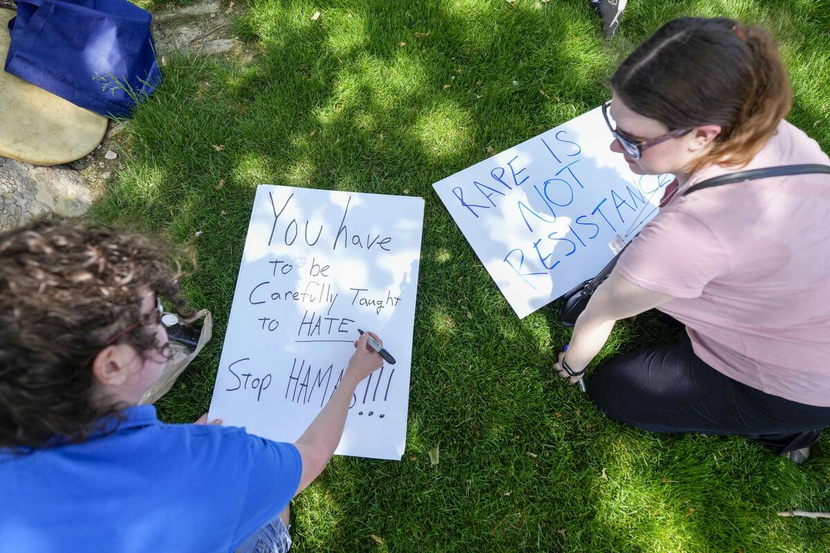 Protestors make signs before a pro-Israel rally at Indiana University in Bloomington, Ind., Thu ...