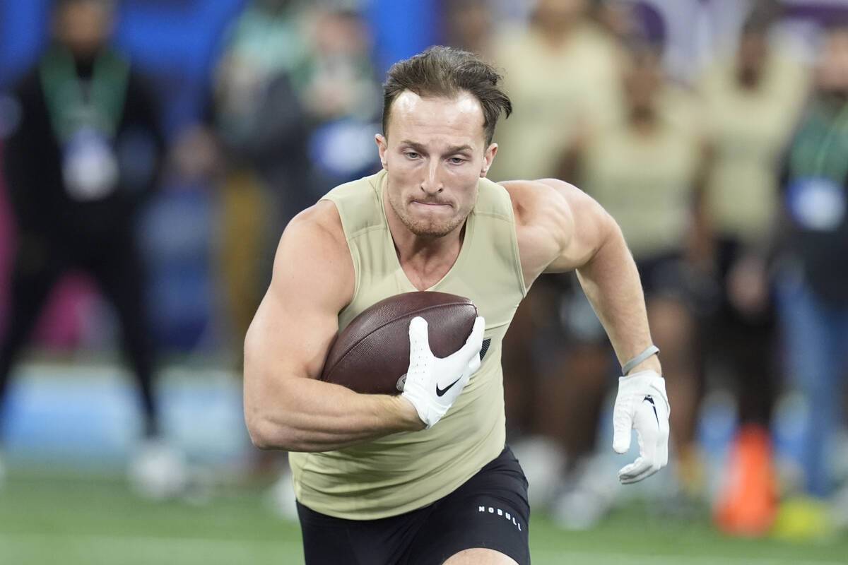 New Hampshire running back Dylan Laube runs a drill at the NFL football scouting combine, Satur ...