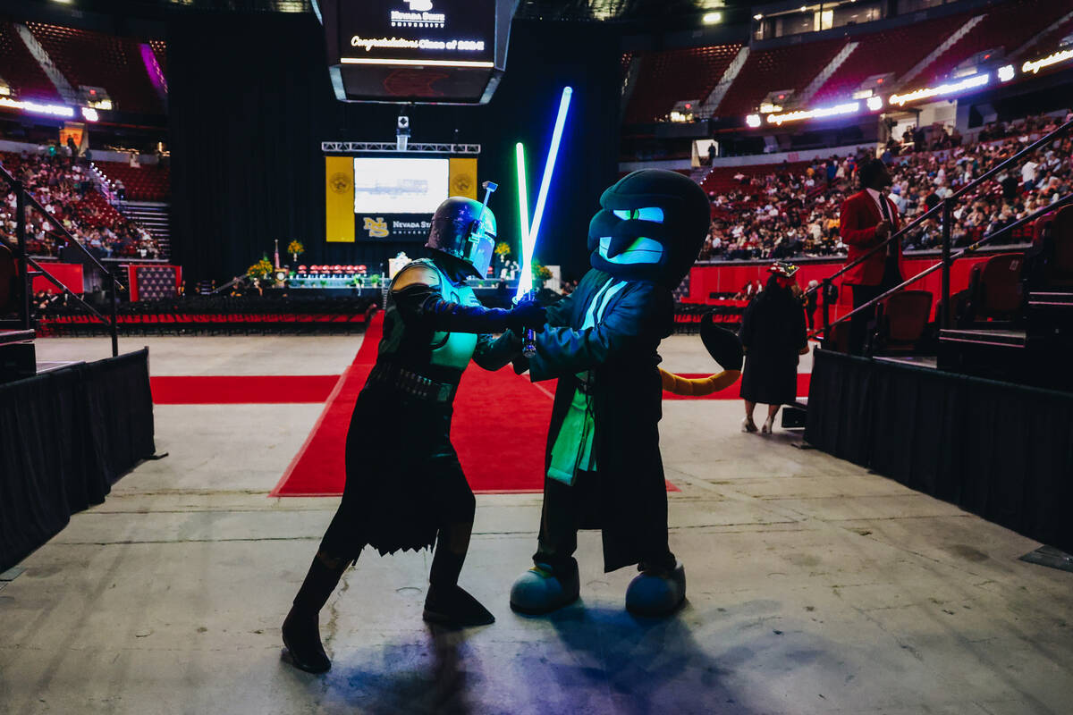 Nevada State mascot Scotty the Scorpion, left, battles a Mandalorian character from “Sta ...