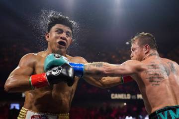 Canelo Alvarez hits Jaime Munguia in a super middleweight title fight Saturday, May 4, 2024, in ...