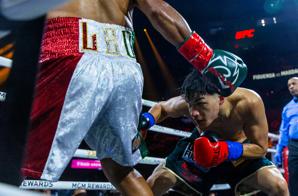 Featherweight Brandon Figueroa goes low to avoid a punch by Jessie Magdaleno Brandon Figueroa d ...