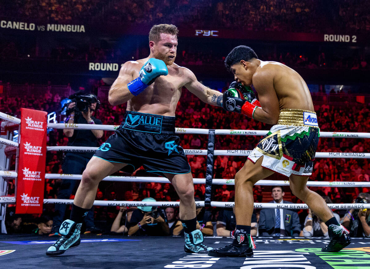 Canelo Alvarez connects with a punch to the chin of Jaime Munguia during the second round of th ...