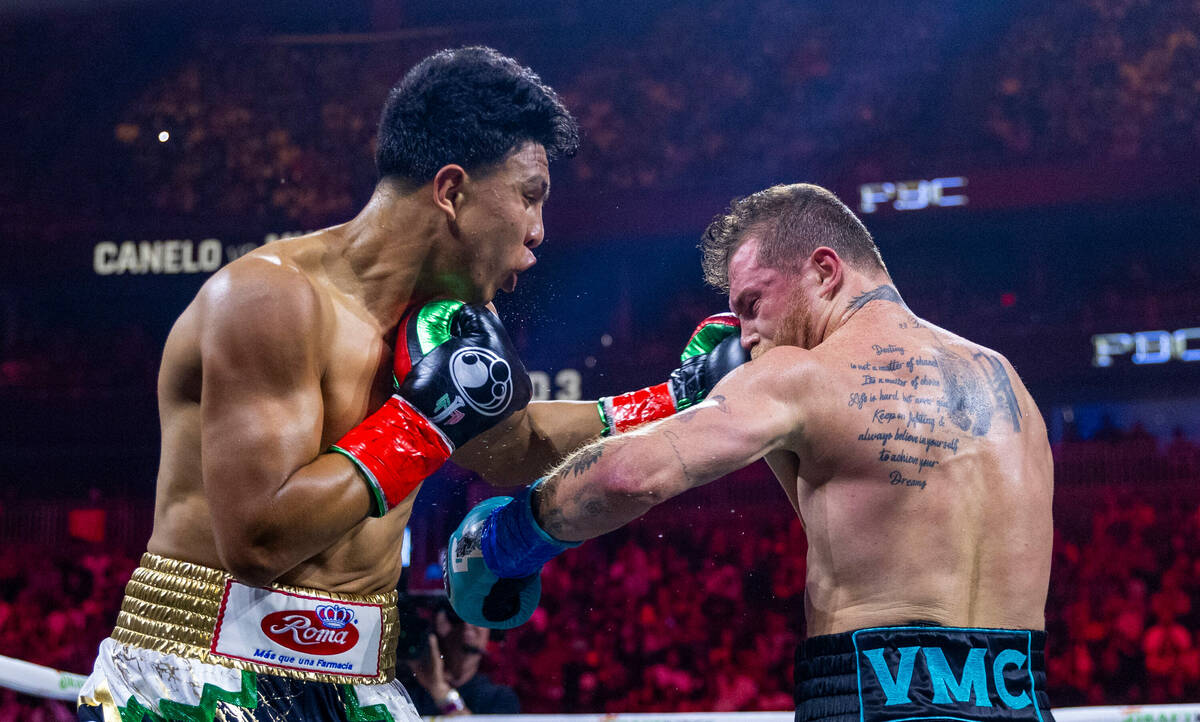 Jaime Munguia connects to the chin of Canelo Alvarez during the third round of their PPV boxing ...