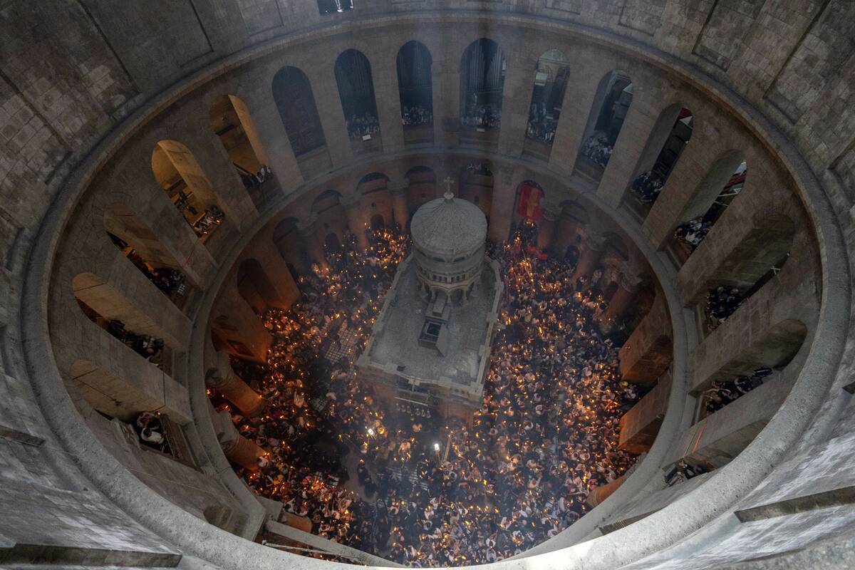 Christian pilgrims hold candles during the Holy Fire ceremony, a day before Easter, at the Chur ...