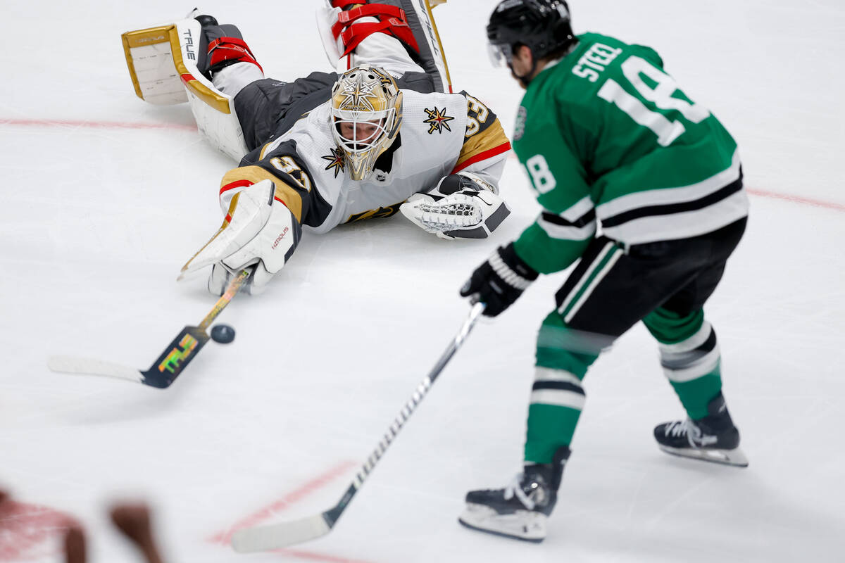 Vegas Golden Knights goaltender Adin Hill, top, leaves his crease to make a save on a breakaway ...