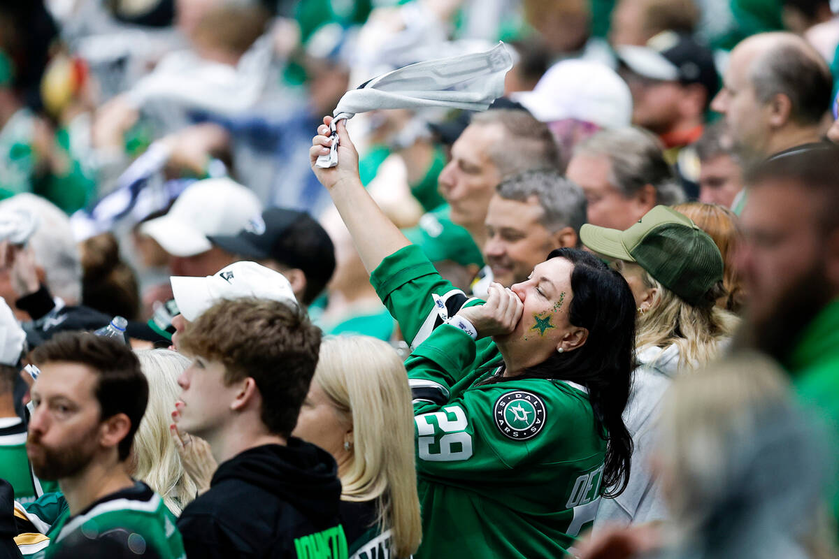 A Dallas Stars fan cheers on the team in Game 7 of an NHL hockey Stanley Cup first-round playof ...