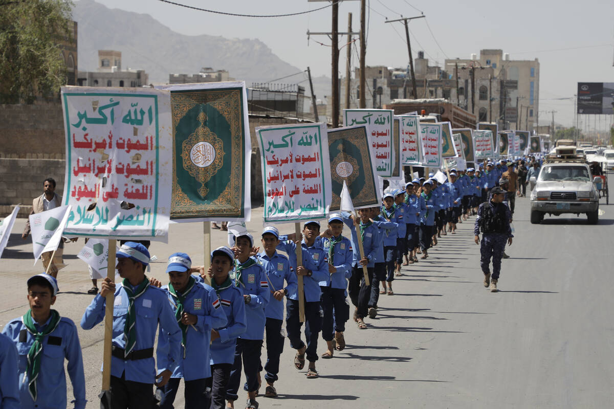 Yemeni students carry anti-Israel and anti-U.S. banners during a march organized by Houthis, to ...