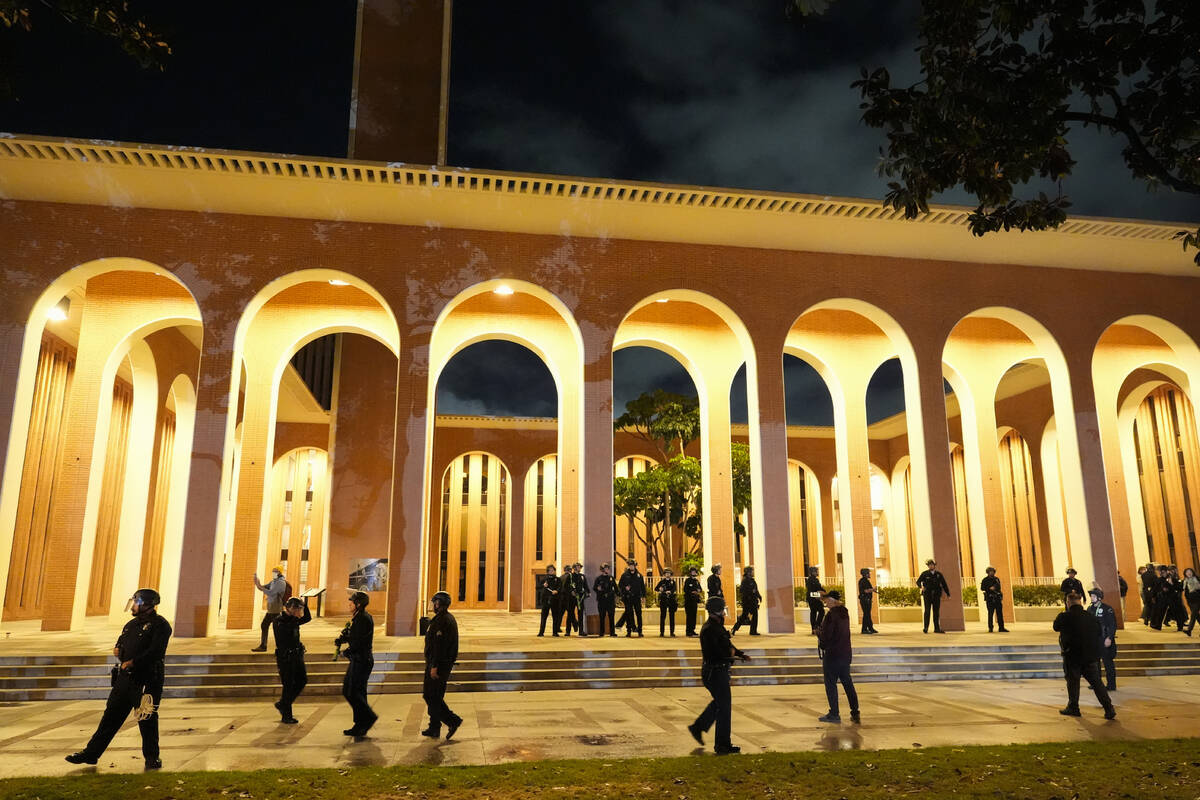 Police gather on the campus at the University of Southern California prior to clearing out an e ...