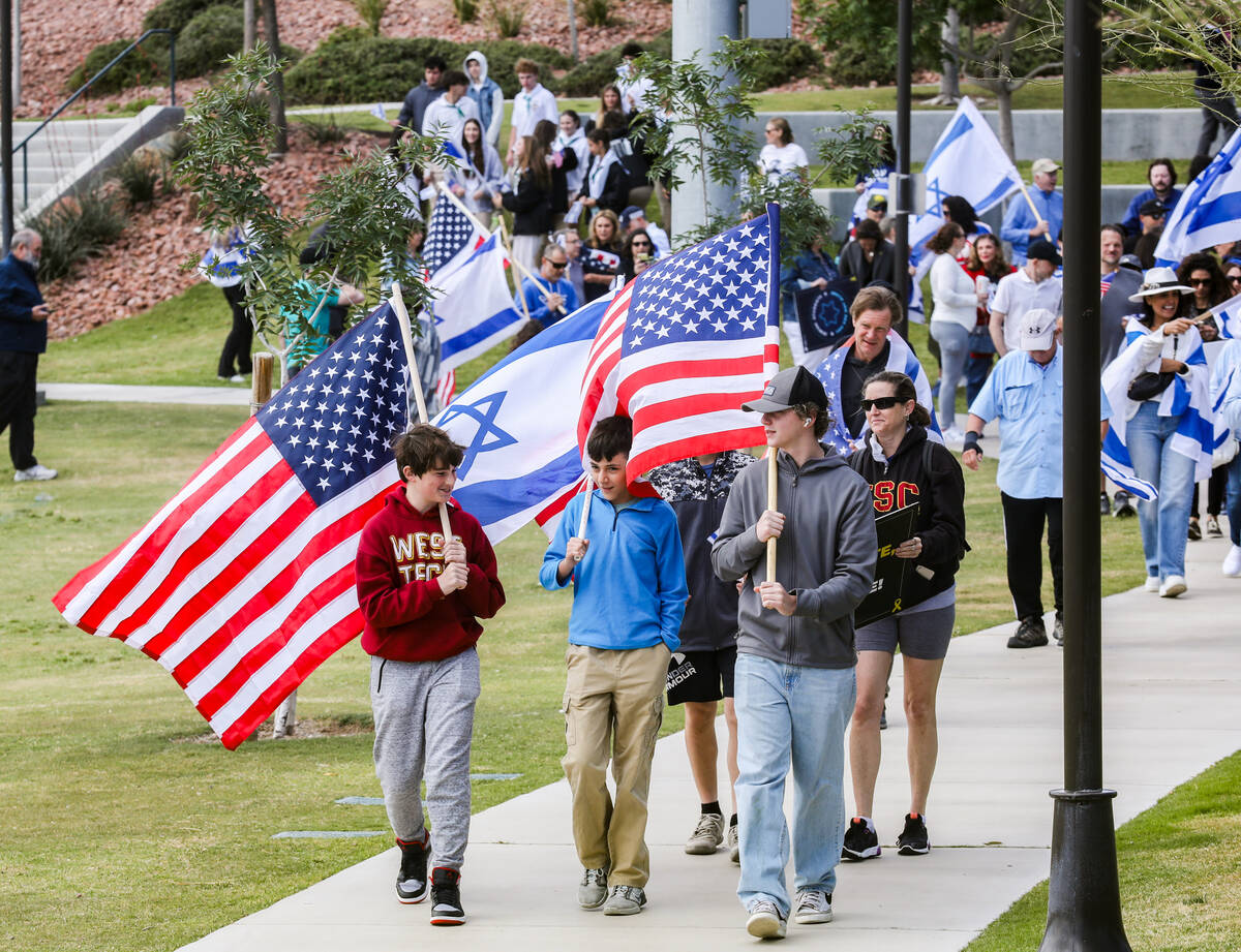 Participants march through Sagemont Park during a rally hosted by the Las Vegas chapter of the ...