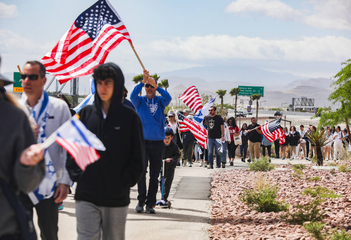 Participants march to the Charleston bridge overpass on the 215 Beltway during a rally hosted b ...