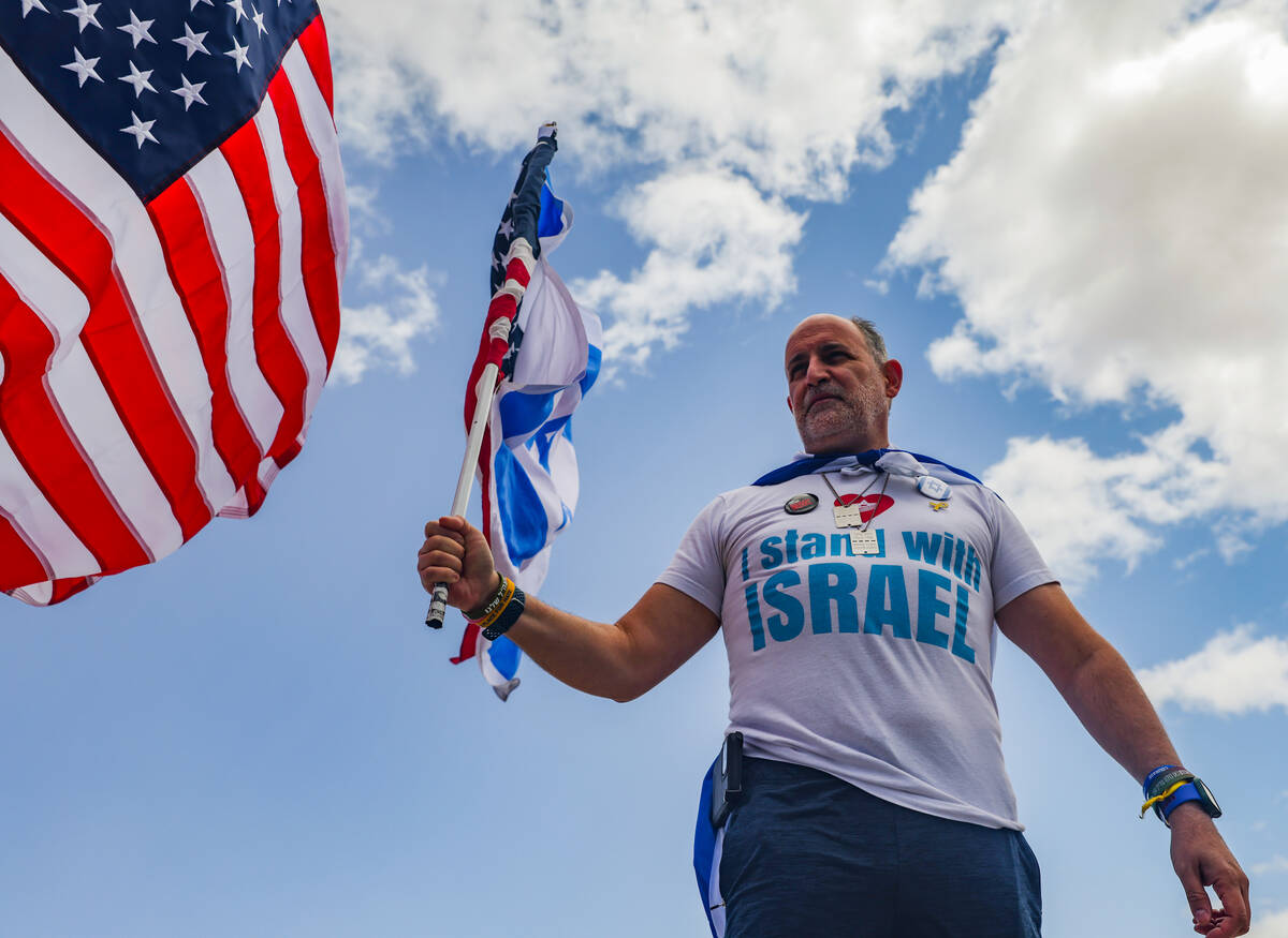 Oded Cohen waves a flag with other participants on the Charleston bridge overpass on the 215 Be ...