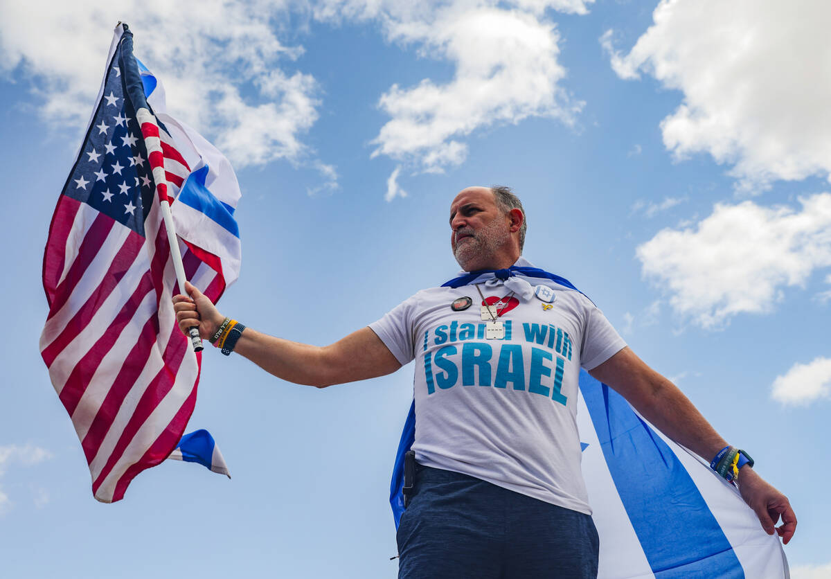 Oded Cohen waves a flag with other participants on the Charleston bridge overpass on the 215 Be ...