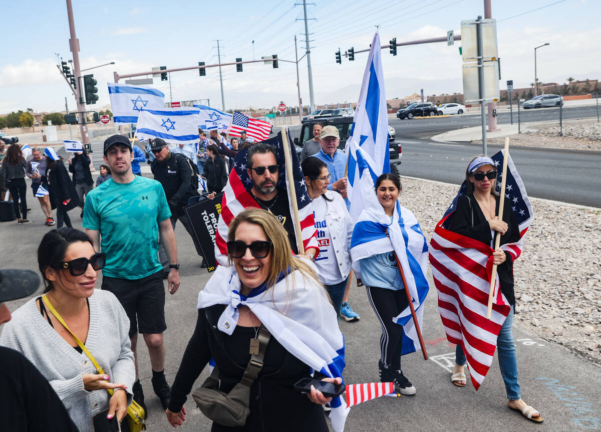 Participants walk back from the Charleston bridge overpass on the 215 Beltway during a rally ho ...
