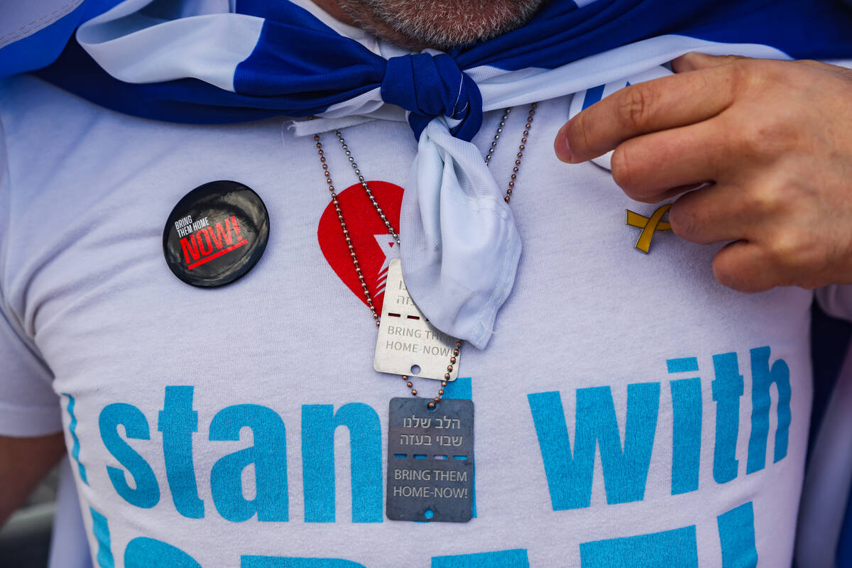 Oded Cohen shows his pro-Israel buttons and necklaces on the Charleston bridge overpass on the ...