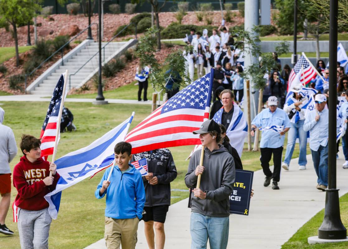 Participants march through Sagemont Park during a rally hosted by the Las Vegas chapter of the ...